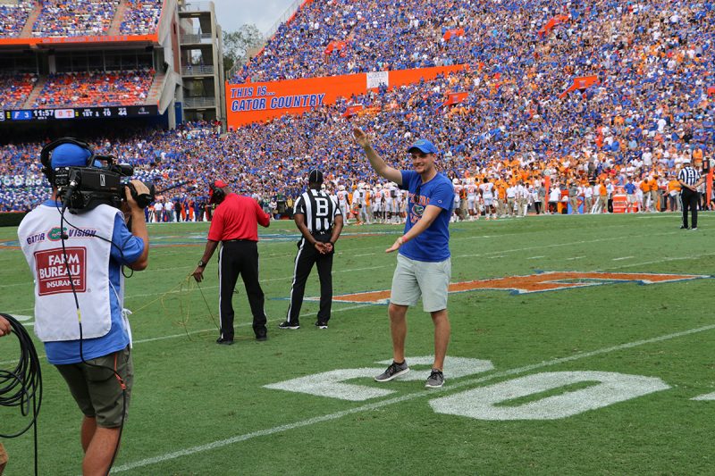 UF Online image of Sports Management major and My First Chomp in The Swamp contest winner Jackson Kewitsch giving a Gator chomp in Ben Hill Griffin Stadium