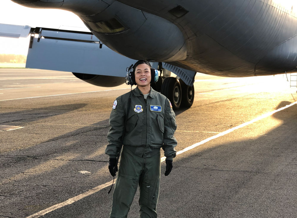 Military student standing next to airplane