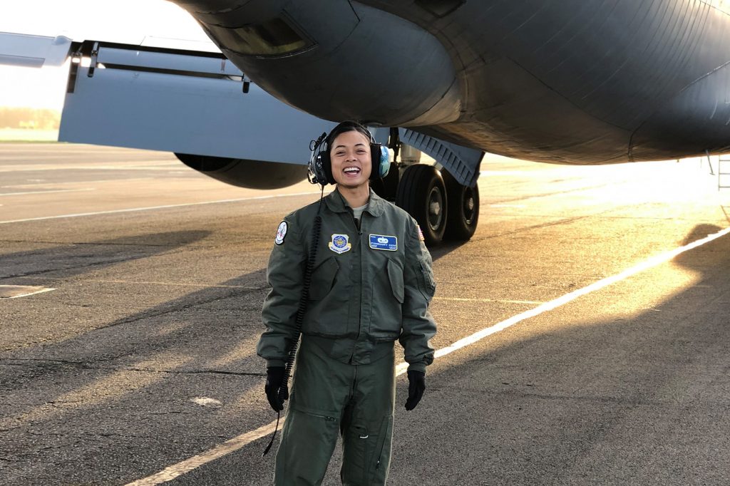 UF Online student Pommary Kem stands with airplane